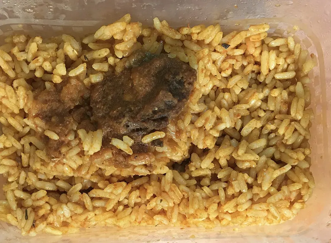 A plate of jollof rice with meat; photography location unrecorded.
